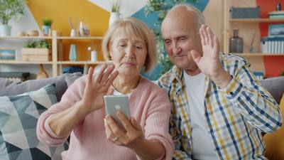 Elderly people man and woman are making online video call talking showing thumbs-up