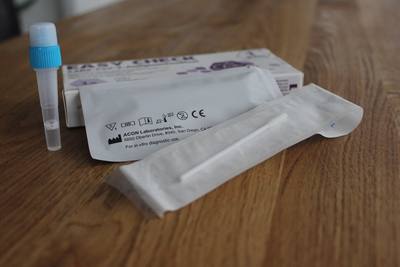 a coronavirus test on a wood table