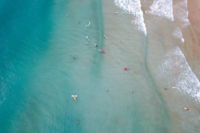 Surfers enjoy the waves at a beautiful beach.