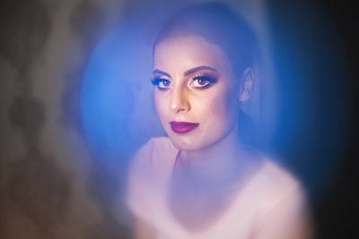 Makeup female model, sitting and looking at camera.