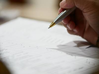 a hand holding a pen
